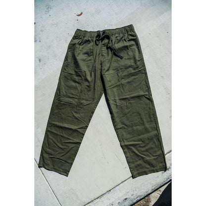 olive Green baggy skate pants on a concrete floor