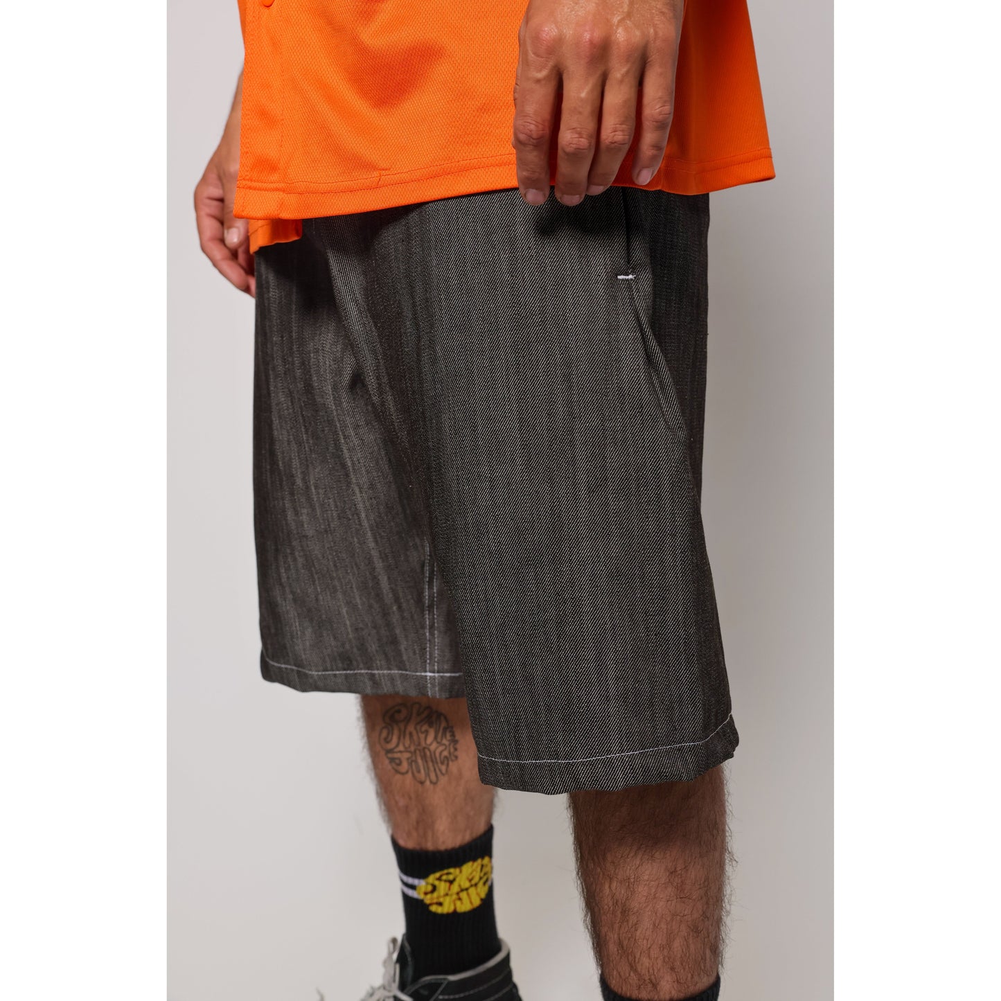 "Over the Knee" skate shorts in black denim with contrast stitching. Workwear style shorts with the wide cut and resilience of 90s denim skatewear for the asphalt. Made in USA.