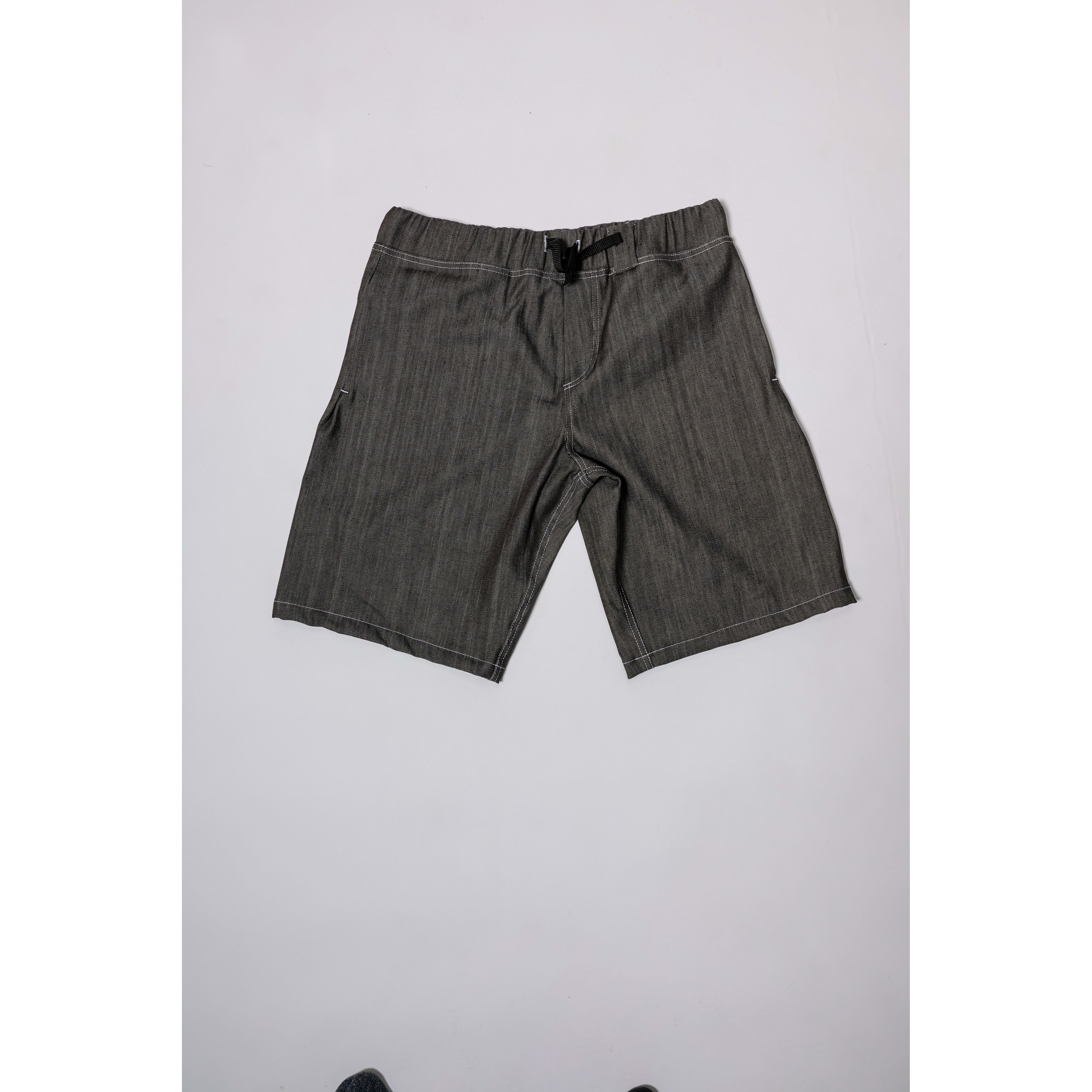 "Over the Knee" skate shorts in black denim with contrast stitching. Workwear style shorts with the wide cut and resilience of 90s denim skatewear for the asphalt. Made in USA.