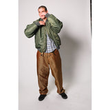 Baggy skate pants in burgundy with a gold stripe. These retro striped skate pants offer a bold 90s street style and a perfect baggy fit for the streets. Made in USA.