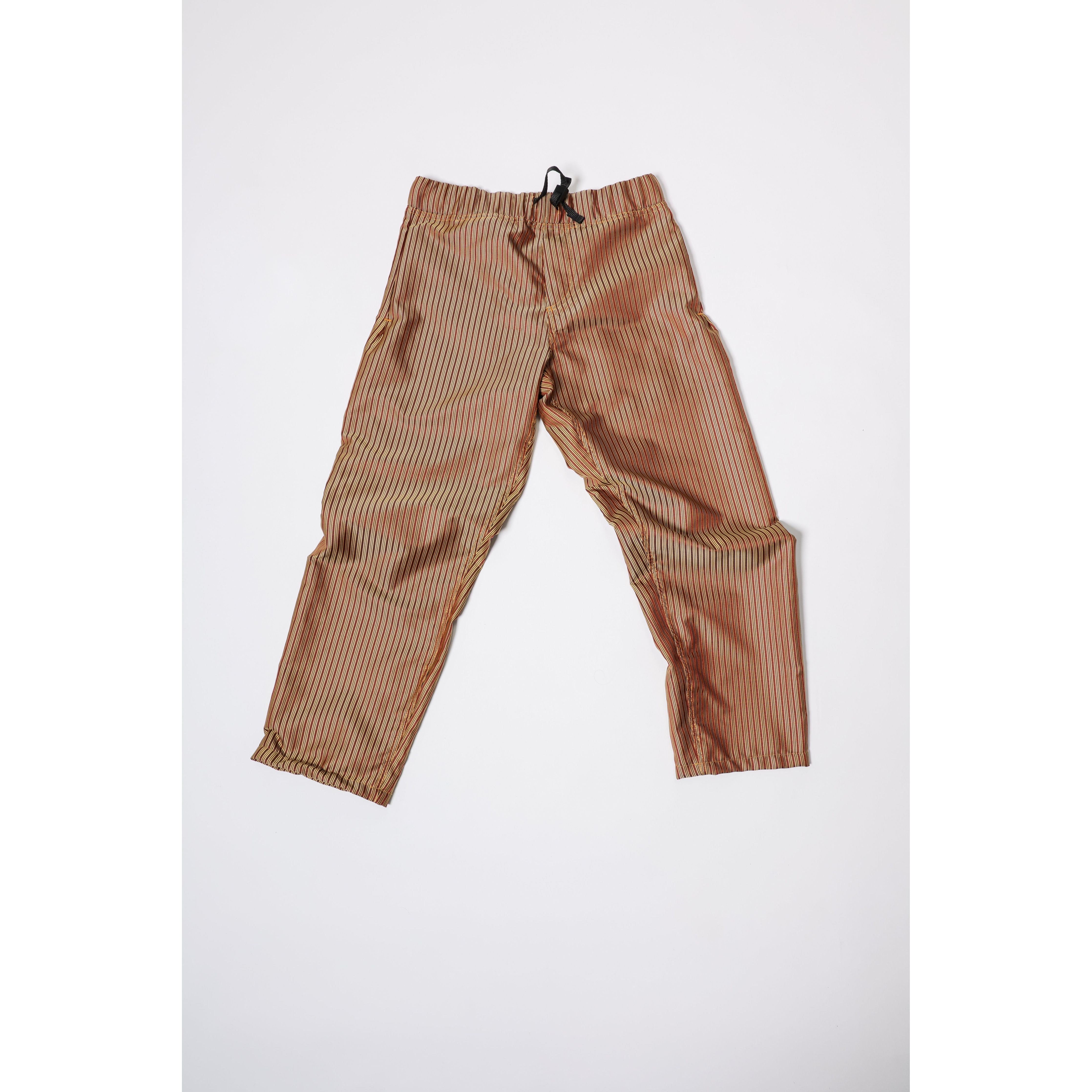 Baggy skate pants in burgundy with a gold stripe. These retro striped skate pants offer a bold 90s street style and a perfect baggy fit for the streets. Made in USA.