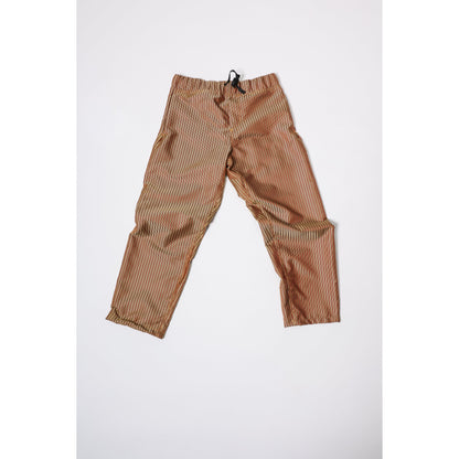 Baggy skate pants in burgundy with a gold stripe. These retro striped skate pants offer a bold 90s street style and a perfect baggy fit for the streets. Made in USA.