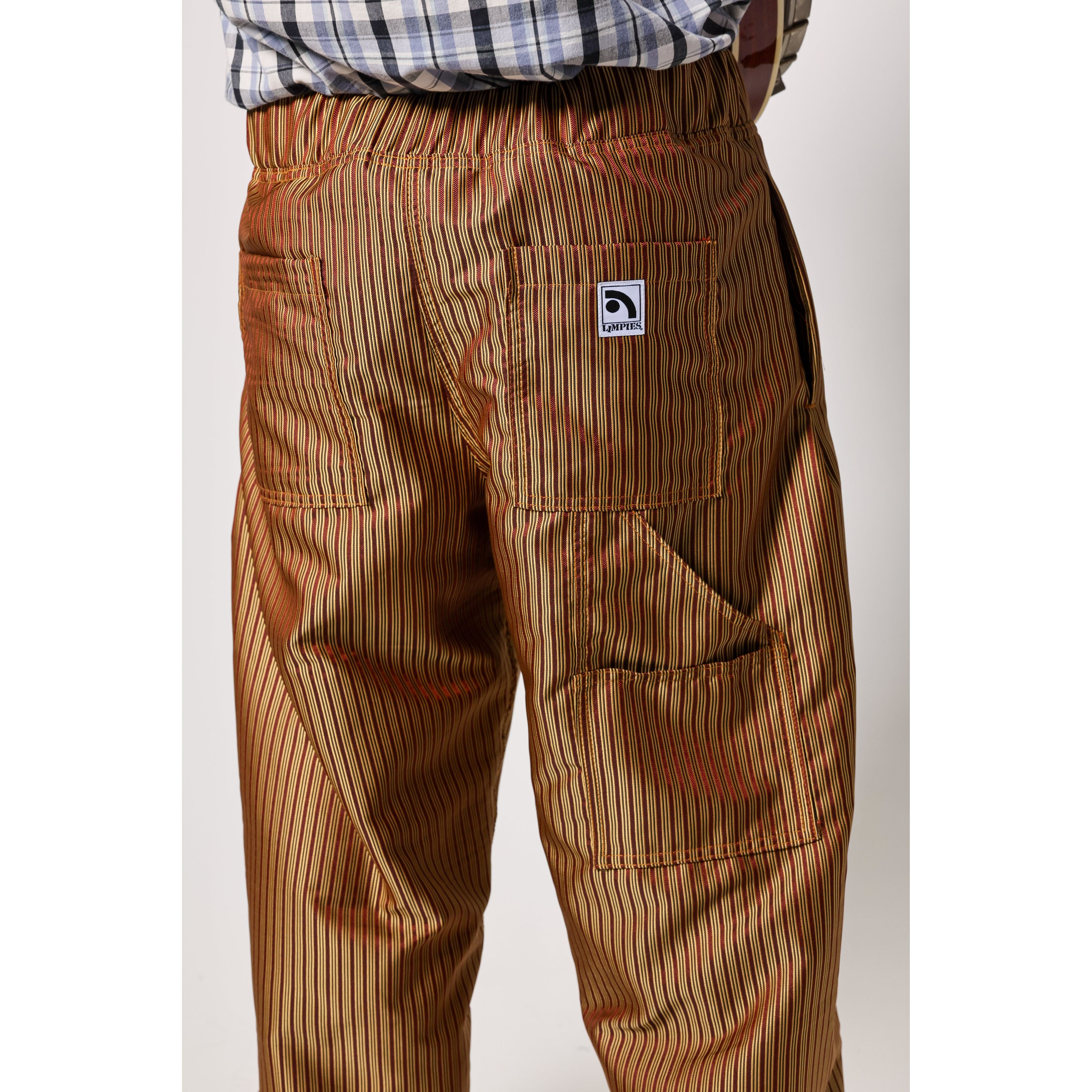 Baggy skate pants in burgundy with a gold stripe. These retro striped skate pants offer a bold 90s street style and a perfect baggy fit for the streets. Made in USA.