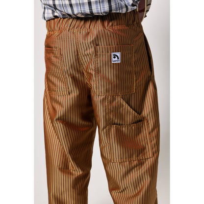 Baggy skate pants in burgundy with a gold stripe. These retro striped skate pants offer a bold 90s street style and a perfect baggy fit for the streets. Made in USA.