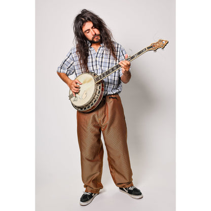 Baggy skate pants in burgundy with a gold stripe. These retro striped skate pants offer a bold 90s street style and a perfect baggy fit for the streets. Made in USA.