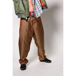 Baggy skate pants in burgundy with a gold stripe. These retro striped skate pants offer a bold 90s street style and a perfect baggy fit for the streets. Made in USA.