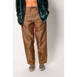 Baggy skate pants in burgundy with a gold stripe. These retro striped skate pants offer a bold 90s street style and a perfect baggy fit for the streets. Made in USA.