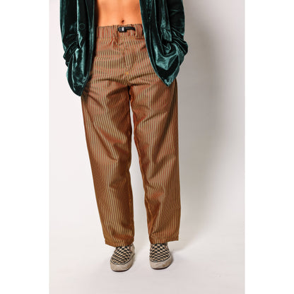 Baggy skate pants in burgundy with a gold stripe. These retro striped skate pants offer a bold 90s street style and a perfect baggy fit for the streets. Made in USA.