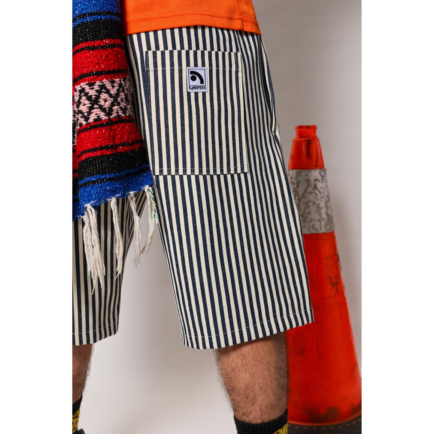 "Over the Knee" skate shorts with a Hickory stripe pattern. The wide cut that recalls retro jorts style and 90s baggy skatewear, maintaining authenticity and urban flow.