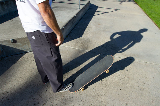 Dark Grey Skate Pant Model with Skateboard