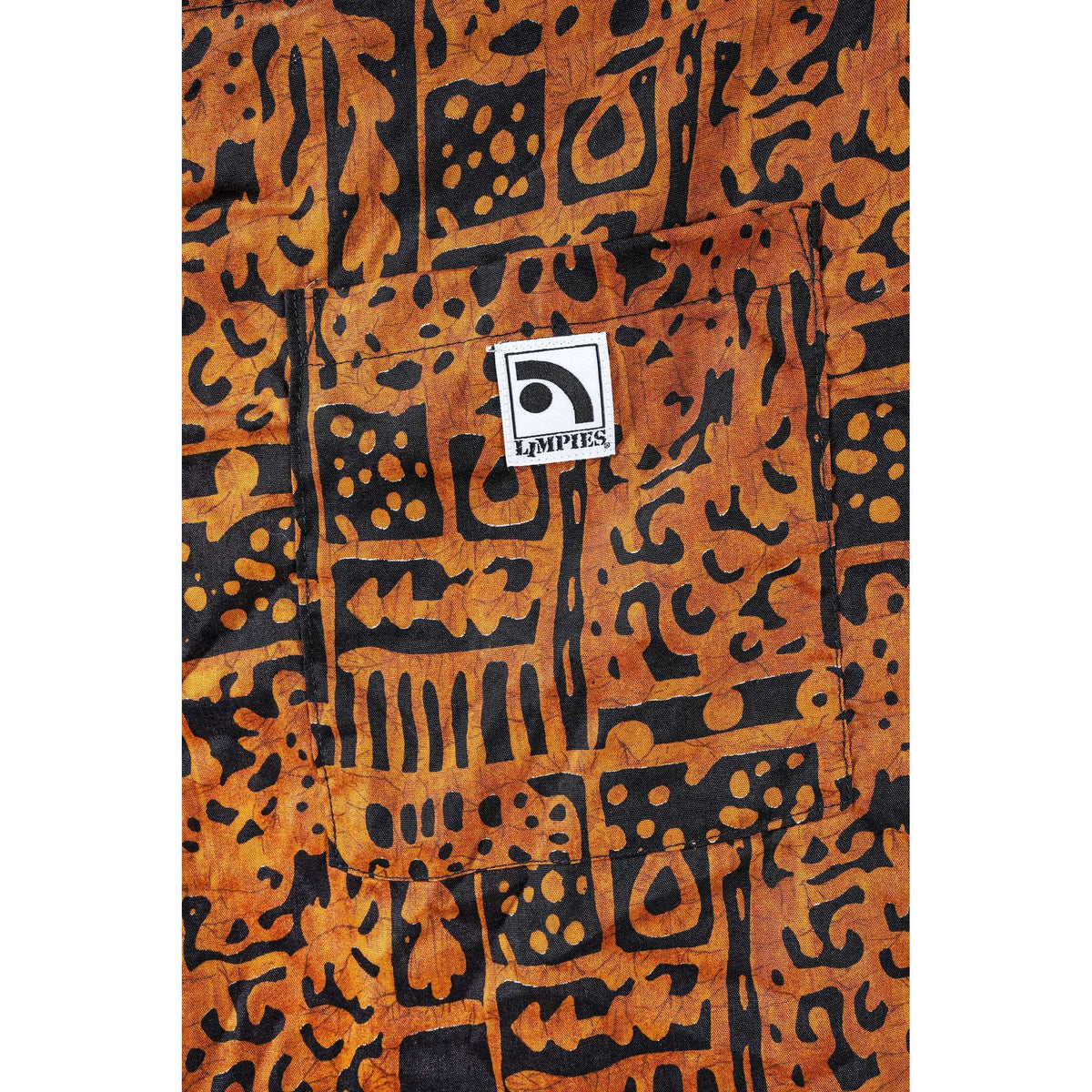 Close-up of a brown and black patterned Limpies baggy skate shorts with a front pocket and a visible square LIMPIES logo patch.