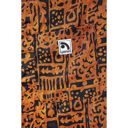 Close-up of a brown and black patterned Limpies baggy skate shorts with a front pocket and a visible square LIMPIES logo patch.