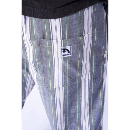 Close-up of striped pants with a front pocket featuring a visible Limpies logo patch, worn with a black top.