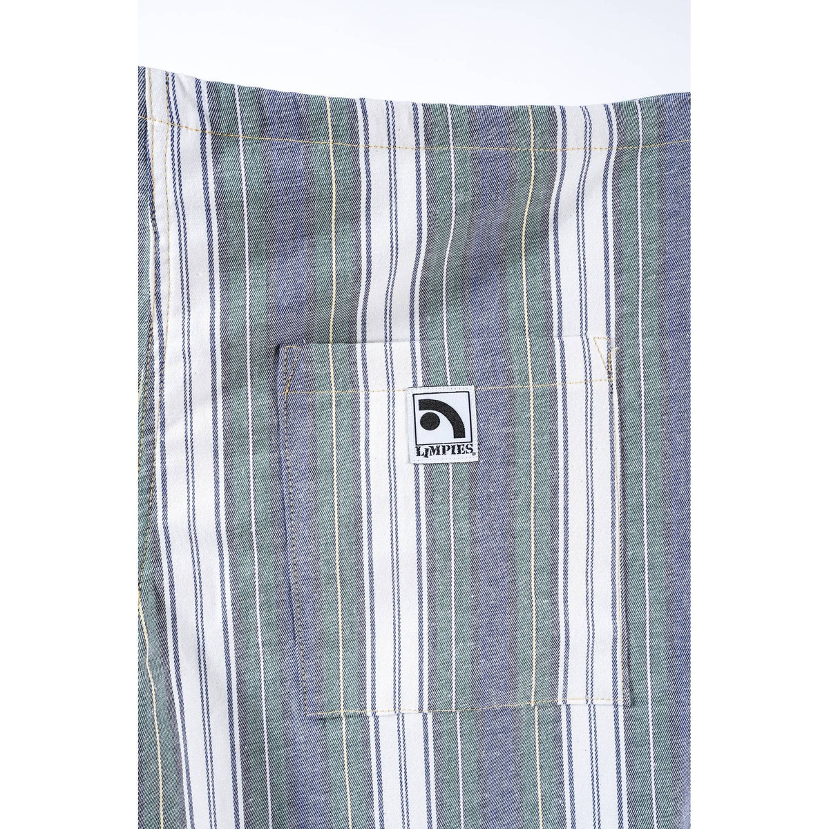 Close-up of a striped garment, likely a shirt or jacket, featuring vertical stripes in muted blue, sage green, and white. A front pocket with a square white brand patch reading 'Limpies' is visible.