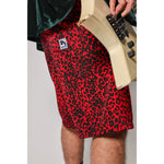 "Over the Knee" skate shorts with a red and black cheetah print. A 90s streetwear print that screams attitude, with the perfect baggy fit for the baggy skate shorts of the era. Made in USA.