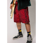 "Over the Knee" skate shorts with a red and black cheetah print. A 90s streetwear print that screams attitude, with the perfect baggy fit for the baggy skate shorts of the era. Made in USA.